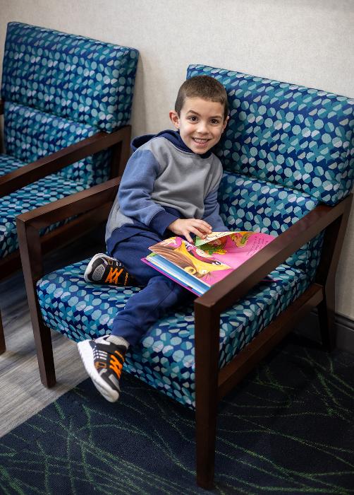 Kid smiling in lobby chair, west chester oh