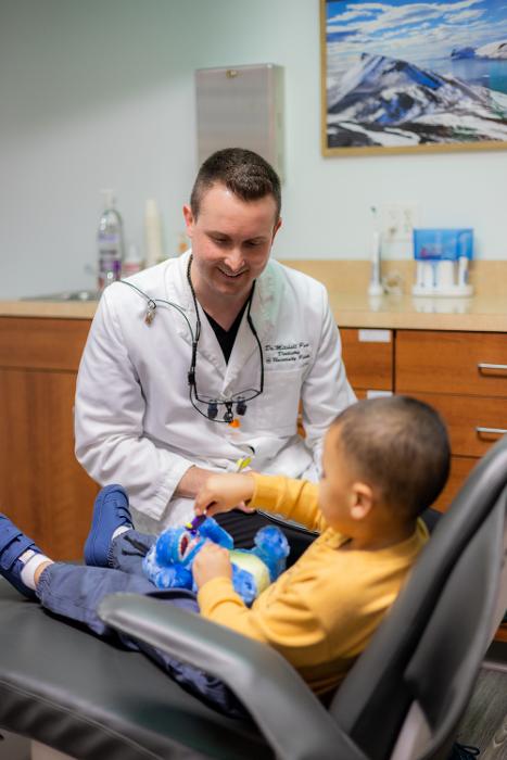 Dr. Mitchell smiling with child patient, west chester oh