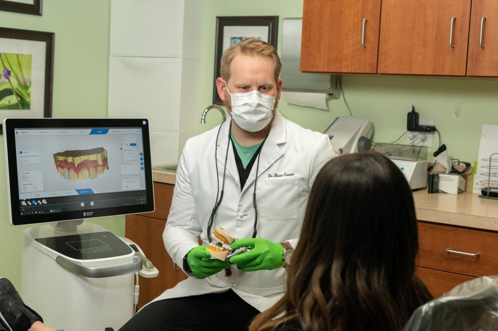 Dr. Caesar showing a mold of a mouth, west chester oh