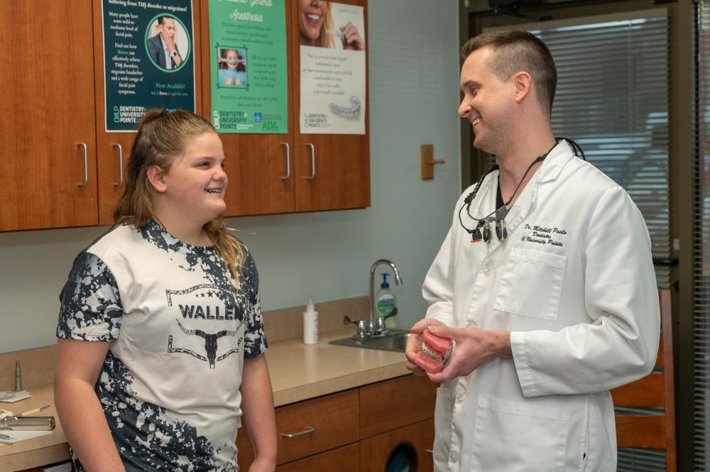 Dr. Mitchell smiling with teenage patient, west chester oh