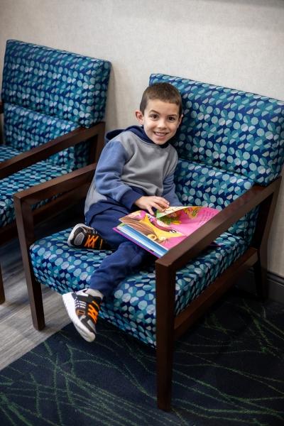 Kid smiling in dental chair lobby, west chester oh