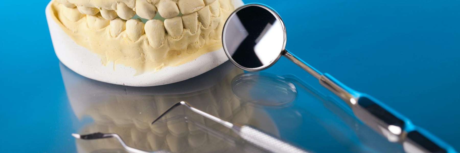 Dental tools next to a mold of teeth, west chester oh