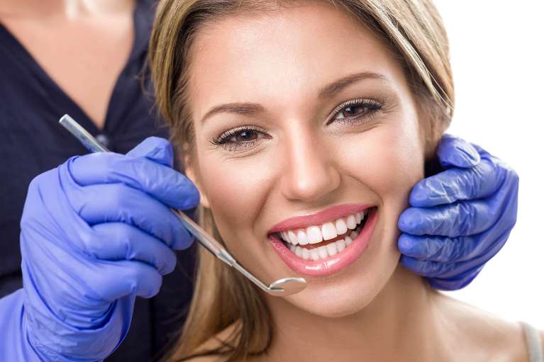 Woman smiling getting teeth cleaned, west chester ohio