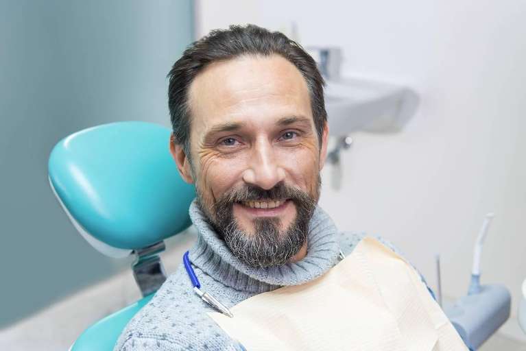 Middle aged man smiling in dental chair, west chester oh