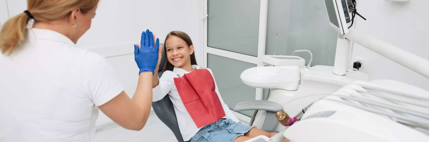 Little girl high fiving a dentist, west chester ohio